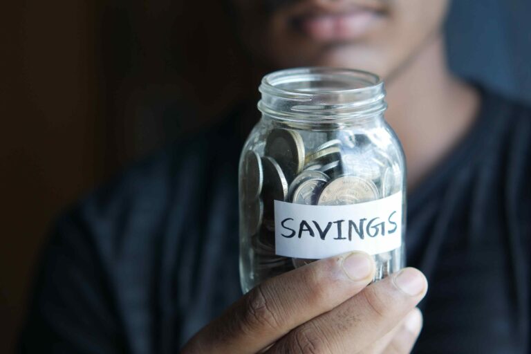 Someone holding a jar with 'Savings' written on it.