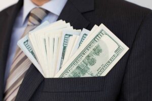 Man with blazer pocket full of money.