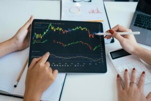Two people looking at a stock performance graph
